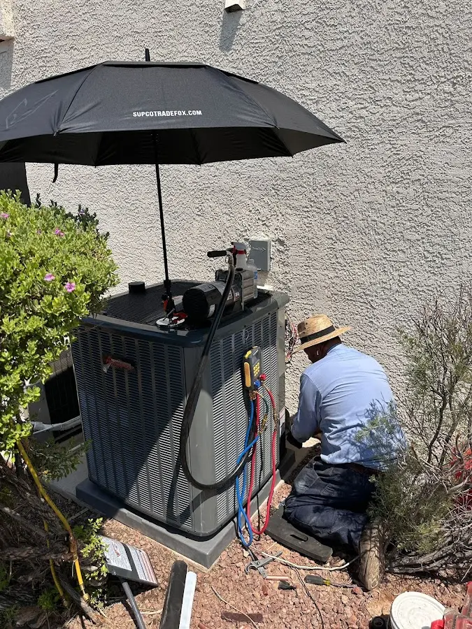 HVAC technician performing outdoor AC maintenance in Beaumont